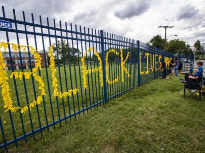 Teachers from Capital City Public Charter School in Northwest Washington, decorate their school fence with yellow paper to spell the words Black Lives Matter, Thursday, June 18, 2020, to support their community in response to the recent protests related to the death of George Floyd, who was killed in police …