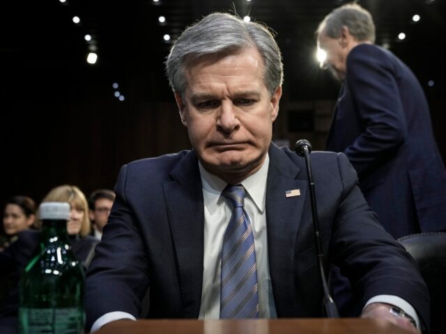 WASHINGTON, DC - MARCH 8: FBI Director Christopher Wray takes his seat as he arrives for a Senate Intelligence Committee hearing concerning worldwide threats, on Capitol Hill March 8, 2023 in Washington, DC. The leaders of the intelligence agencies testified on a wide range of issues, including China, Covid-19 origins, …