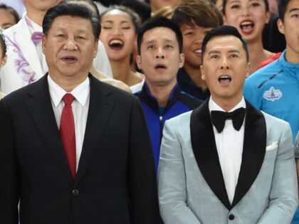 China's President Xi Jinping (C), together with Hong Kong's outgoing chief executive Leung Chun-ying (L) and incoming chief executive Carrie Lam (R) sing a song entitled "My Country" with Hong Kong performer Lisa Wang (2nd L) and actor Donnie Yen (2nd R) as Xi joins performers at the end of …