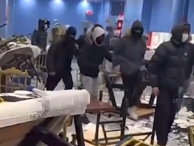 A group of vandals wearing hoods and masks can be seen in a video ransacking a New York Ci