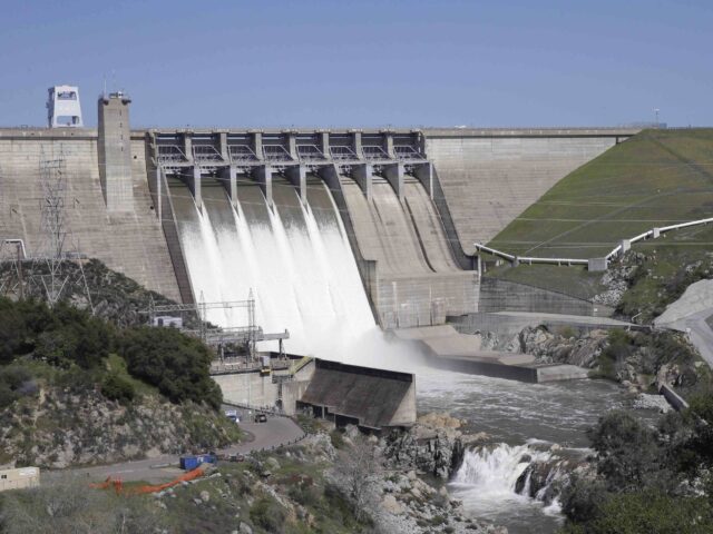FILE - In this March 18, 2016, file photo, water flows from five of the eight flood gates