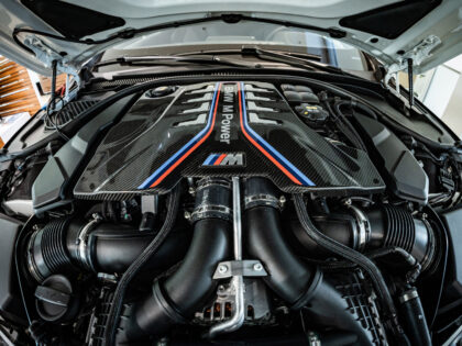 A BMW M Power combustion engine sits under the hood of an automobile inside a Bayerische M