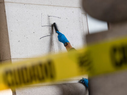 UNITED STATES - FEBRUARY 2: A worker uses a wire brush to clean off swastikas that were drawn on the exterior of Union Station in Washington, D.C., on Wednesday, February 2, 2022. An arrest was made for the vandalism that occurred last week. (Photo By Tom Williams/CQ-Roll Call, Inc via …