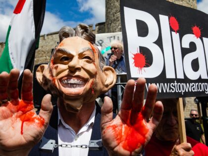 A Stop the War Coalition activist wearing a mask and daubed in fake blood protests outside Windsor Castle against the awarding of a knighthood to former Prime Minister Sir Anthony Blair, who they believe should be held accountable for his controversial role in the Iraq War, on 13th June 2022 …