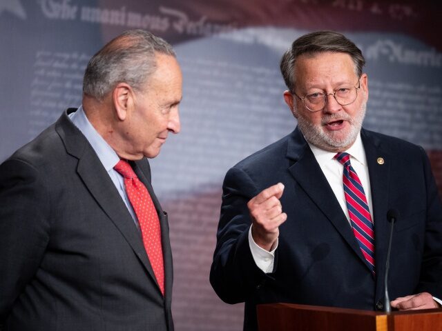 UNITED STATES - DECEMBER 7: Senate Majority Leader Chuck Schumer, D-N.Y., left, and DSSC chairman Sen. Gary Peters, D-Mich., hold their news conference in the Capitol on Wednesday, December 7, 2022, to discuss Sen. Raphael Warnocks runoff win. (Bill Clark/CQ-Roll Call, Inc via Getty Images)