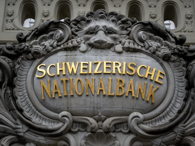 A sign of the Swiss National Bank (SNB) is seen on its headquarters ahead of a press conference in Bern on December 15, 2022. - The Swiss central bank on December 15, 2022 raised its key interest rate by 50 basis points to 1%, continuing to tighten monetary policy despite …