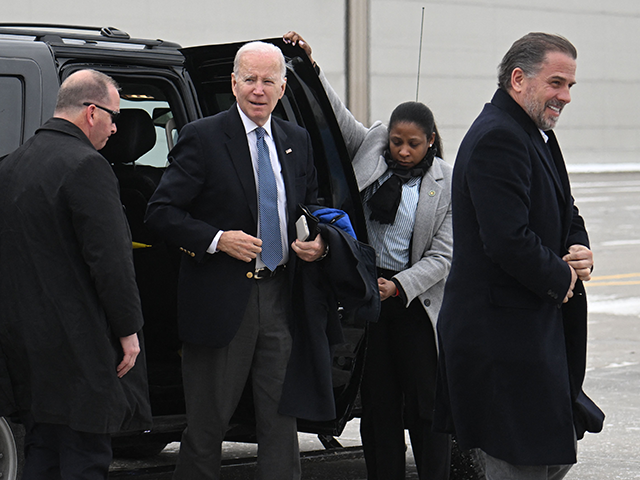 President Joe Biden, with son Hunter Biden (R), arrives to board Air Force One at Hancock