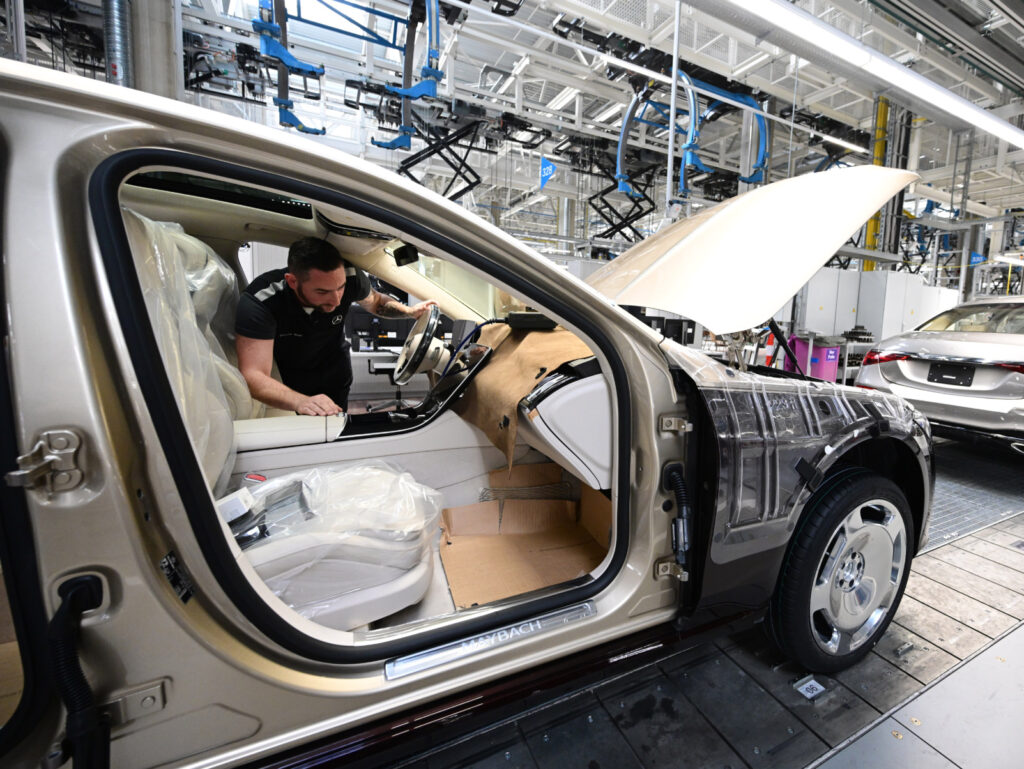 PRODUCTION - 13 February 2023, Baden-Württemberg, Sindelfingen: Employees of the Stuttgart-based car manufacturer Mercedes-Benz work on the production line for luxury and luxury-class vehicles in Factory 56 at the Merecdes-Benz plant in Sindelfingen. In addition to the EQS, all variants of the Mercedes-Benz S-Class and the Mercedes-Maybach S-Class come off the production line at Factory 56. The company will present its 2022 business figures on Friday. Photo: Bernd Weißbrod/dpa (Photo by Bernd Weißbrod/picture alliance via Getty Images)