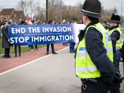 ROTHERHAM, UNITED KINGDOM - 2023/02/18: Anti-immigration demonstrators hold a banner outside the Holiday Inn hotel which is housing refugees. An anti-immigration protest was organized outside the hotel housing asylum seekers waiting for claims to be processed. A counter-protest was also staged by Stand Up To Racism. (Photo by Andy Barton/SOPA …