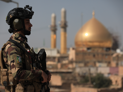 A soldier stands in front of Al-Askari mosque, Resting Place of the Two Imams Ali al-Hadi