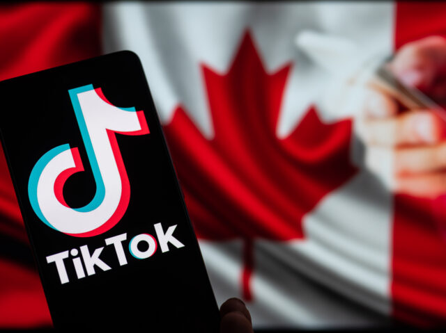 TikTok displayed on mobile with on screen Canada flag, seen in this photo illustration. On 28 February 2023 in Brussels, Belgium. (Photo by Jonathan Raa/NurPhoto via Getty Images)