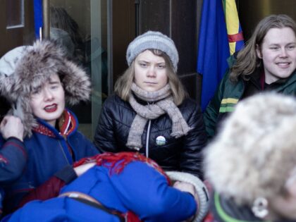 Swedish climate activist Greta Thunberg (C) together with young climate protesters from the "Nature and Youth" and "Norwegian Samirs Riksforbund Nuorat" groups block the entrance of Norway's Energy Ministry to protest against wind turbines built on land traditionally used to herd reindeer, in Oslo, on February 28, 2023. - Climate …