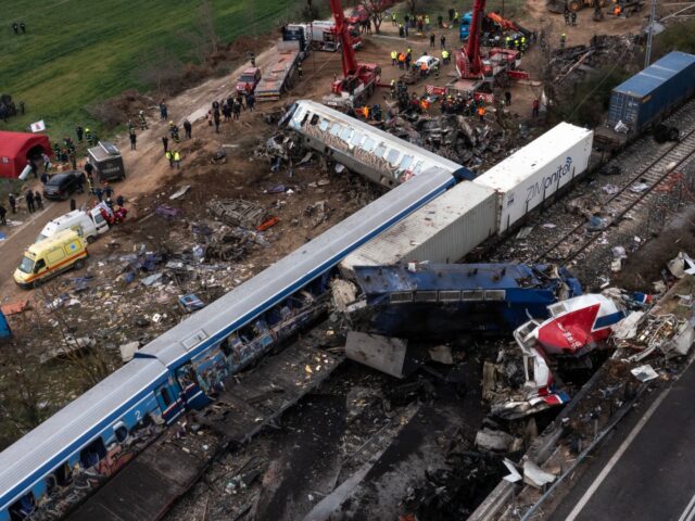 Rescue workers at the site of a derailed passenger train following a collision with a carg