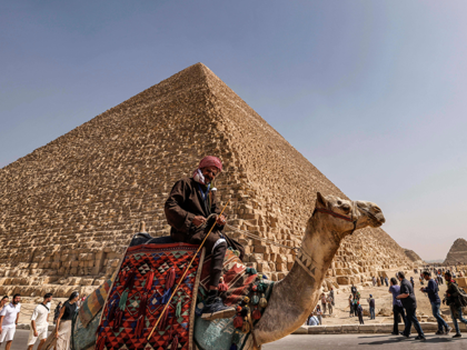 Tourists visit the Great Pyramid of Khufu (Cheops) at the Giza Pyramids necropolis on the southwestern outskirts of Cairo, on March 2, 2023. - A hidden corridor of 9 metres long has been spotted close to the main entrance of the pyramid, a discovery made under the Scan Pyramids project …