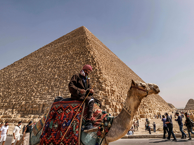 Tourists visit the Great Pyramid of Khufu (Cheops) at the Giza Pyramids necropolis on the