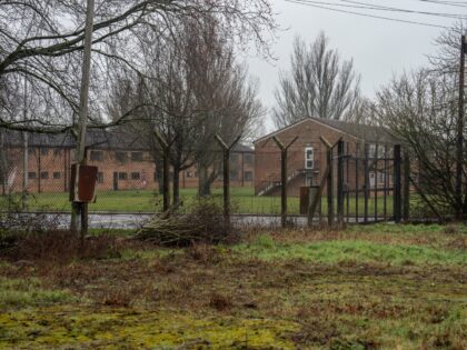 WETHERSFIELD, ENGLAND - MARCH 09: Accommodation blocks are pictured behind a perimeter fence at MDP Wethersfield, a former Royal Air Force base, is pictured on March 9, 2023 in Wethersfield, England. Braintree District Council has been approached by the government to discuss using the former RAF/USAF base as accommodation for …