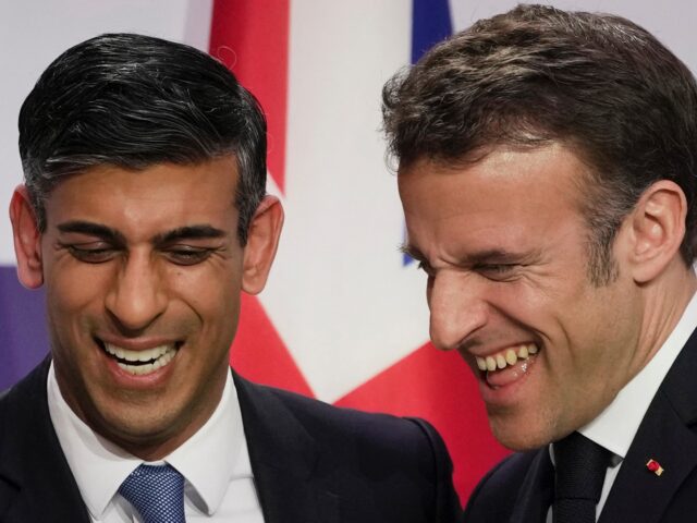 TOPSHOT - Britain's Prime Minister Rishi Sunak (L) and France's President Emmanuel Macron (L) react as they speak during a joint press conference at the end of the French-British summit, at the Elysee Palace, in Paris, on March 10, 2023 - British Prime Minister Rishi Sunak and French President Emmanuel …