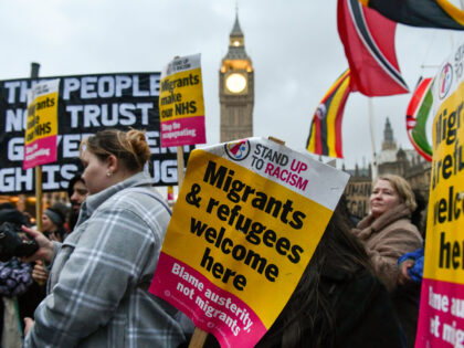 LONDON, UNITED KINGDOM - 2023/03/13: Protesters seen gathered in Parliament Square, with placards and banners during a pro-migration rally in London. Pro migration activists gathered in Parliament Square, today evening to protest against the proposed Nationality and Borders bill, which if enacted, will make sweeping changes to way the UK …