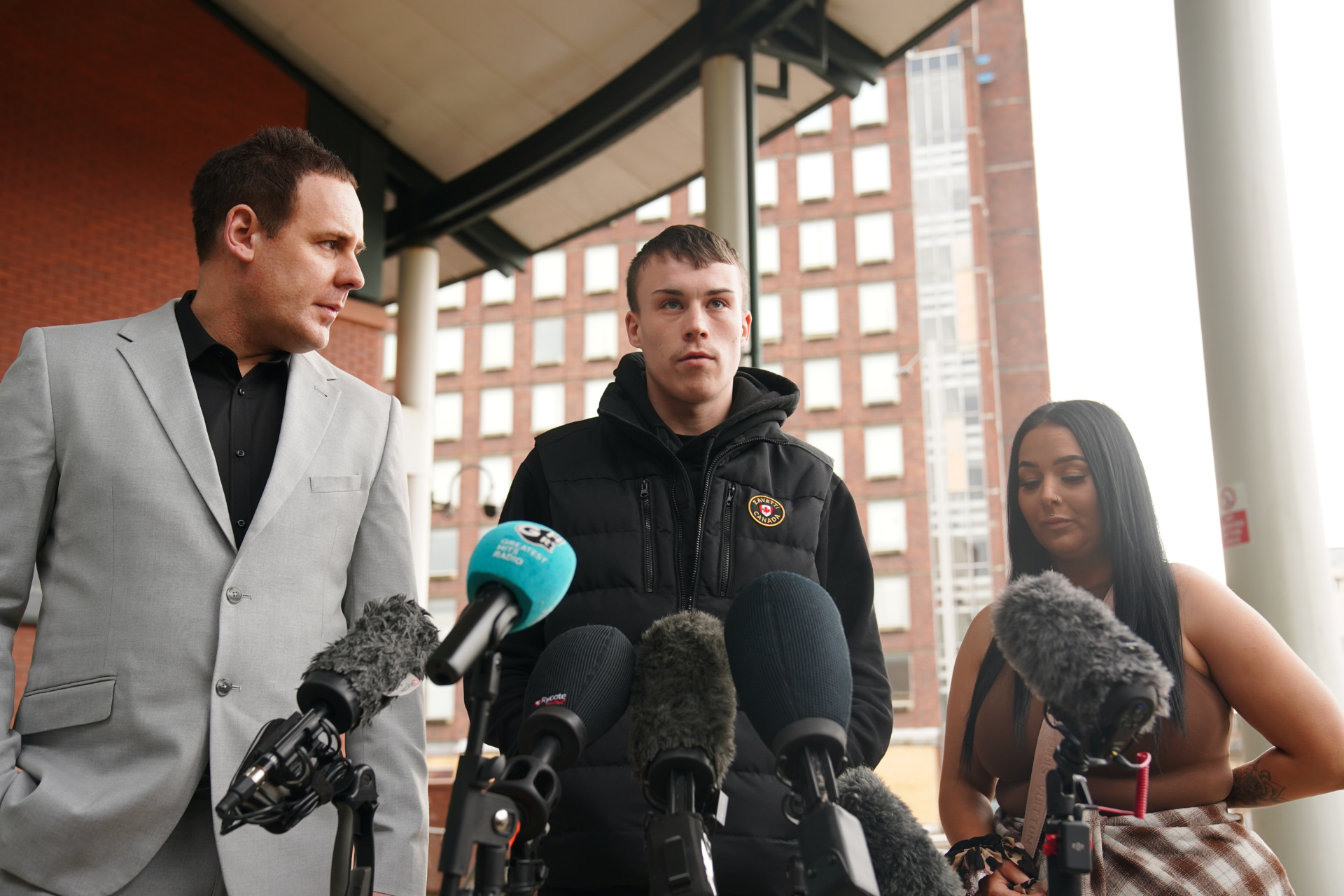 Jordan Trengove (centre), who was accused of trafficking by Eleanor Williams, speaking to the media outside Preston Crown Court, Lancashire, where she was jailed for eight-and-a-half years for nine counts of perverting the course of justice after she claimed to have been the victim of an Asian grooming gang. Williams, 22, published pictures of her injuries and an account of being groomed, trafficked and beaten, on Facebook in May 2020, in a post which was shared more than 100,000 times. Picture date: Tuesday March 14, 2023. (Photo by Peter Byrne/PA Images via Getty Images)