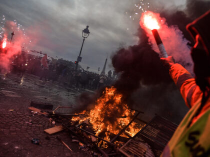 PARIS, FRANCE - March 16: Protesters set fire as clashes take place with riot police durin