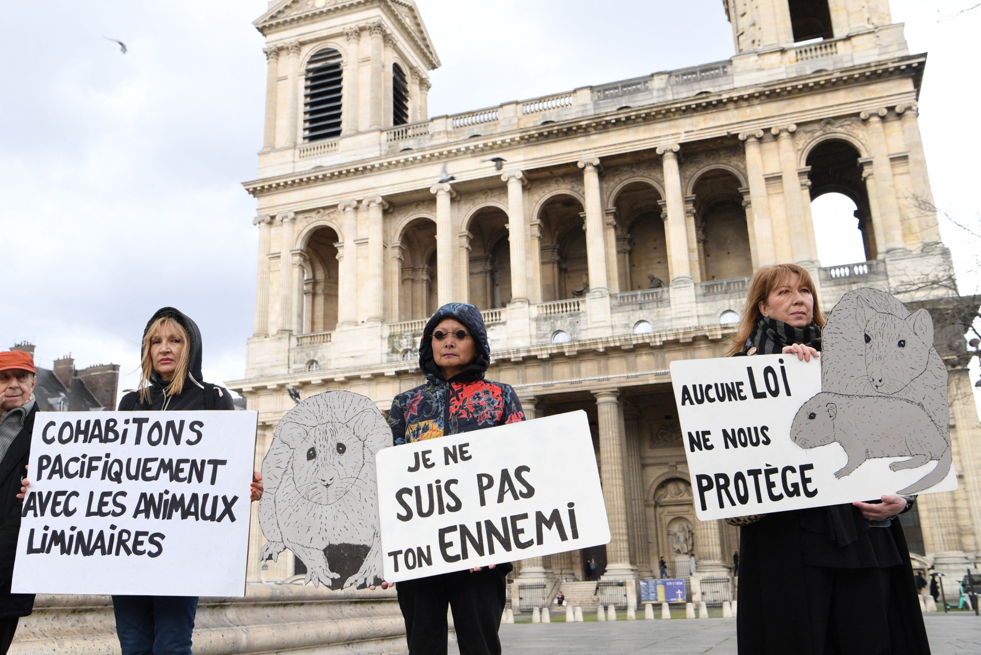Members of the Paris Animaux Zoopolis (PAZ) association hold placards during a rally to call for the protection of liminal animals (rats, pigeons), in Paris on March 18, 2023. (Photo by Bertrand GUAY / AFP) (Photo by BERTRAND GUAY/AFP via Getty Images)