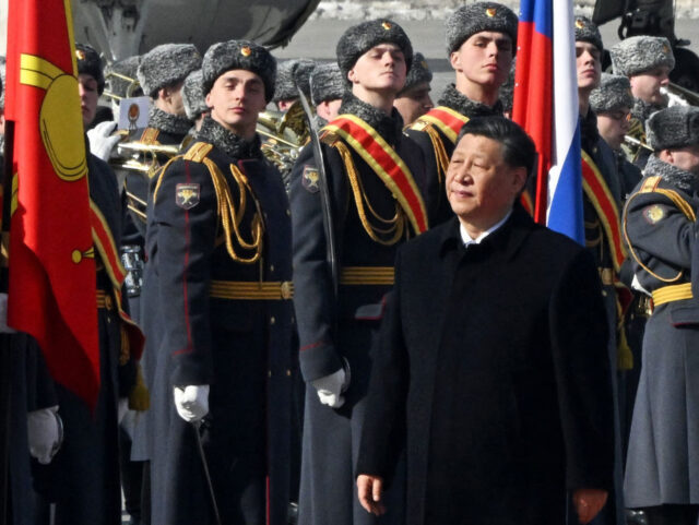 China's President Xi Jinping walks past honour guards during a welcoming ceremony at Moscow's Vnukovo airport on March 20, 2023. - Chinese leader arrived in Moscow on Monday saying his first state visit to Russia since the Ukraine conflict broke out would give "new momentum" to bilateral ties. (Photo by …