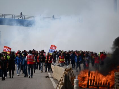 TOPSHOT - Oil worker gather outside the refinery in protest after the government announced the first requisition of oil workers since the beginning of the strikes against the pension reform, at the Fos-sur-Mer depot near Marseille on March 21, 2023, a decision that could inflame tensions in an inflammatory political …
