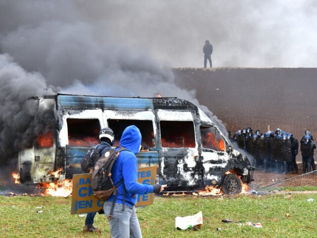 A French gendarme vehicle burns during clashes as part of a demonstration called by the collective "Bassines non merci", the environmental movement "Les Soulevements de la Terre" and the French trade union 'Confederation paysanne' to protest against the construction of a new water reserve for agricultural irrigation, in Sainte-Soline, central-western …