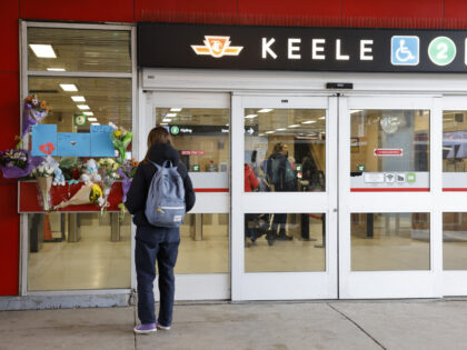 TORONTO, ON - March 27 - A person stops to look at the memorial outside Keele subway stati