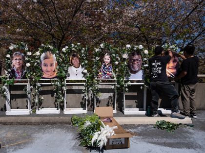 Pictures of the victims killed in a mass shooting on Monday at The Covenant School are fixed to a memorial by Noah Reich (left) and David Maldonado from the non-profit Classroom of Compassion, near the school on March 29, 2023 in Nashville, Tennessee. Three students and three adults were killed …