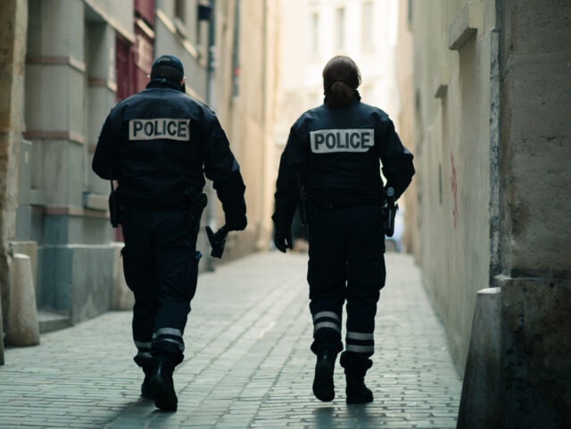 Paris, France - April 2012: A pair of police officers with the word "POLICE" wri