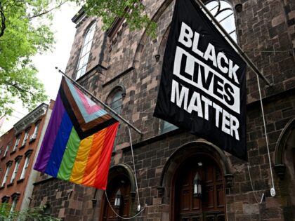 NEW YORK, NEW YORK - JUNE 13: A progress pride flag and a Black Lives Matter flag are displayed outside a church on June 13, 2021 in the Brooklyn Borough of New York City. On May 19, 2021 New York Governor Andrew Cuomo lifted all coronavirus pandemic restrictions paving the …