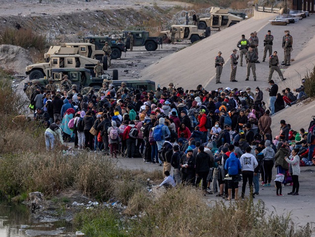 CIUDAD JUAREZ, MEXICO - DECEMBER 20: Texas National Guard troops block immigrants from ent