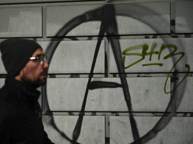 TURIN, ITALY - MARCH 04: General view of anarchist symbol written on a wall after the prot