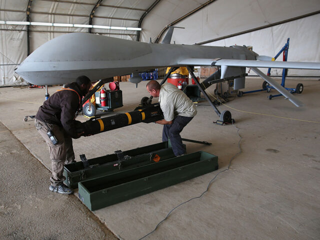 UNSPECIFIED, UNSPECIFIED - JANUARY 07: Contract workers load a Hellfire missile onto a U.