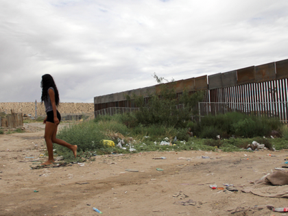 A local girl walks near the higher new metal wall installed by US workers to replace fencing along the border between Ciudad Juarez and Sunland Park, New Mexico, in Juarez, Chihuahua state, Mexico on September 12, 2016. / AFP / HERIKA MARTINEZ (Photo credit should read HERIKA MARTINEZ/AFP via Getty …
