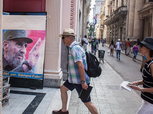 Chinese tourists in a shop of souvenirs about the cuban revolution in Havana, Cuba, on 23