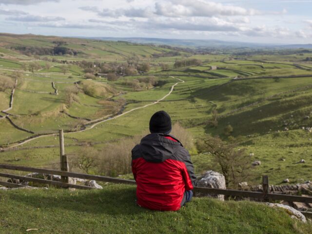 A walker near Malham Cove in the Yorkshire Dales National Park, on 12th April 2017, in Mal