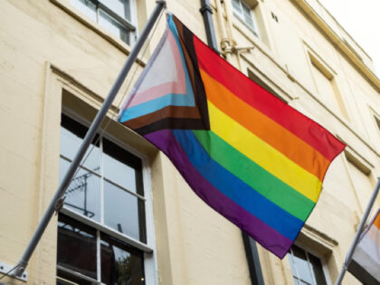 A Progress Pride flag and a Bear flag are pictured above a Soho street on 12 November 2022