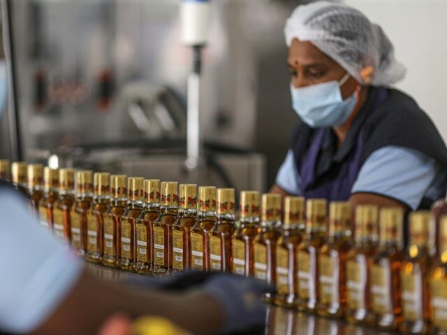 Whiskey bottles travel on conveyor belts inside a bottling plant of Diageo Plc., in Bengal