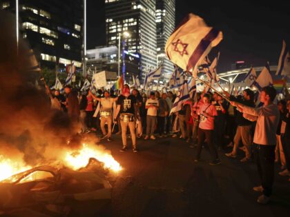 Israelis opposed to Prime Minister Benjamin Netanyahu's judicial overhaul plan set up bonfires and block a highway during a protest moments after the Israeli leader fired his defense minister, in Tel Aviv, Israel, Sunday, March 26, 2023. Defense Minister Yoav Gallant had called on Netanyahu to freeze the plan, citing …