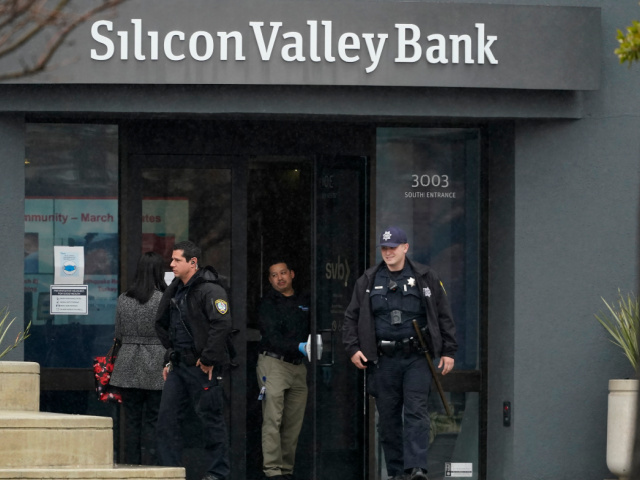 Santa Clara Police officers exit Silicon Valley Bank in Santa Clara, Calif., Friday, March