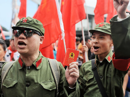 HONG KONG - MAY 01: Protesters dressed as a Chinese Red Guards chant during a rally on May 1, 2014 in Tsim Sha Tsui, Hong Kong. People from Hong Kong stage a satirical rally to urge Chinese tourists to stay in Mainland China. (Photo by Anthony Kwan/Getty Images)