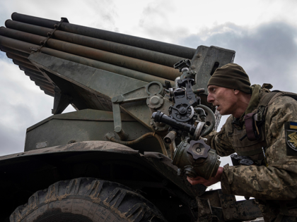 A Ukrainian paratrooper of 95 Air Assault brigade aims to fire by MSLR BM-21 "Grad" toward