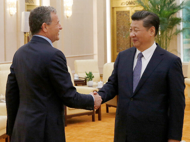 China's President Xi Jinping (R) talks with Chief Executive Officer of Disney Bob Ige