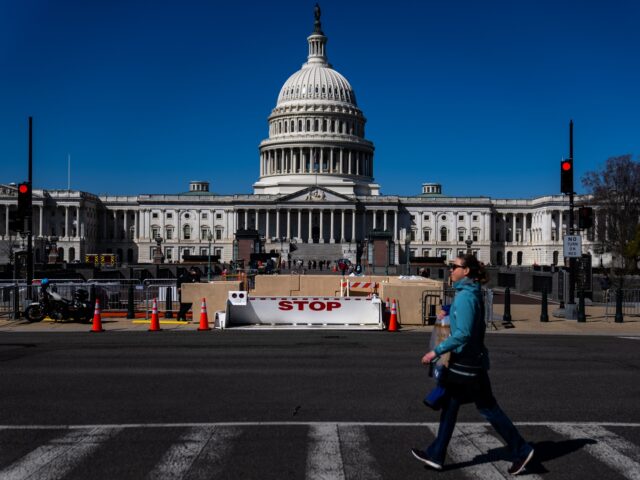 WASHINGTON, DC - MARCH 20: A person crosses the street in view of the U.S. Capitol Building on Monday, March 20, 2023 in Washington, DC. (Kent Nishimura / Los Angeles Times via Getty Images)