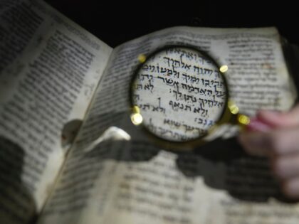 A member of staff shows the Hebrew Bible "Codex Sassoon", that dates back more than 1,000 years, on display during a media preview of Sotheby's auction, in London, Wednesday, Feb. 22, 2023. The piece has an estimated price of US$30-50 million and will go on auction on May in New …