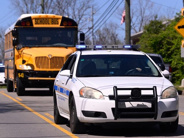 Metro Nashville Police cars escort evacuees from the school and church on schools buses as