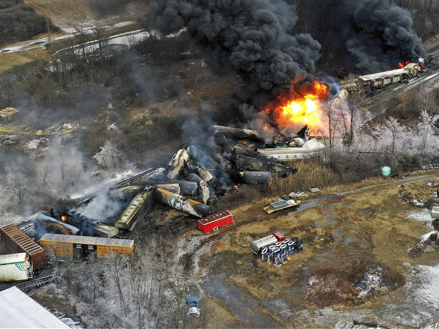 FILE - This photo taken with a drone shows portions of a Norfolk Southern freight train that derailed Friday night in East Palestine, Ohio are still on fire at mid-day Saturday, Feb. 4, 2023. On Friday, Feb 24, The Associated Press reported on stories circulating online incorrectly claiming a photo shows birds that “dropped dead” in Kentucky following the Ohio train derailment, and a video shows birds in northern Indiana that also died from the hazardous chemicals released after the derailment. (AP Photo/Gene J. Puskar, File)