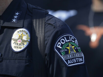 Members of the Austin police department march with members of the University of Texas foot